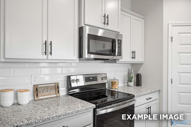 3713 Jaguar Way, Huntsville, AL 35810 - kitchen with stainless steel appliances, backsplash, white cabinets, and light stone countertops