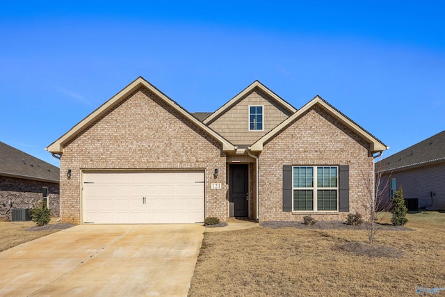 craftsman-style house with a garage and central AC unit