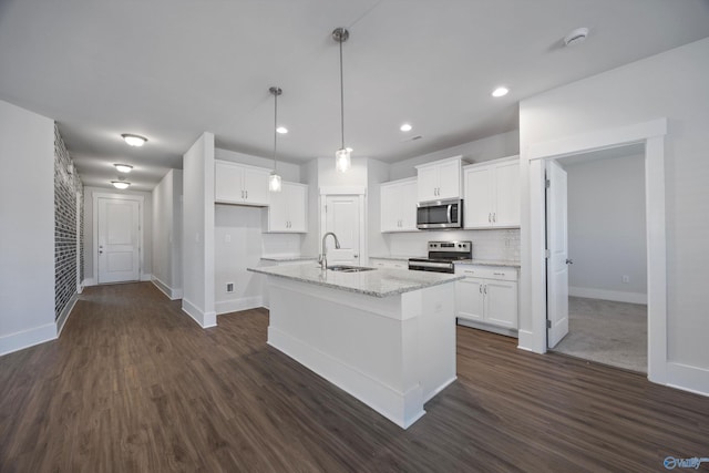 kitchen featuring sink, an island with sink, white cabinets, and appliances with stainless steel finishes