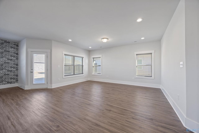 unfurnished room featuring dark wood-type flooring