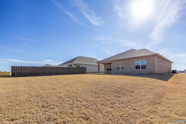 back of property with a lawn