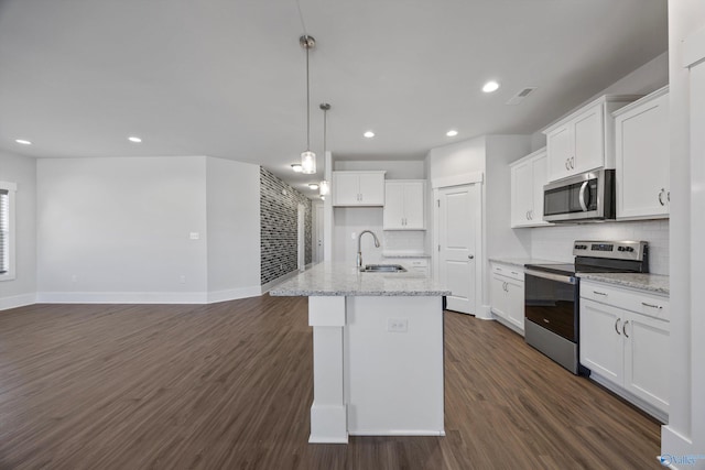 kitchen featuring white cabinetry, an island with sink, appliances with stainless steel finishes, and sink