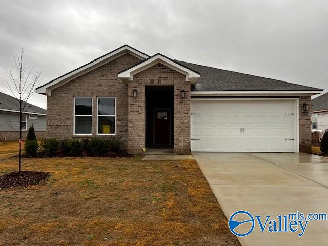 view of front of house with a garage and a front lawn