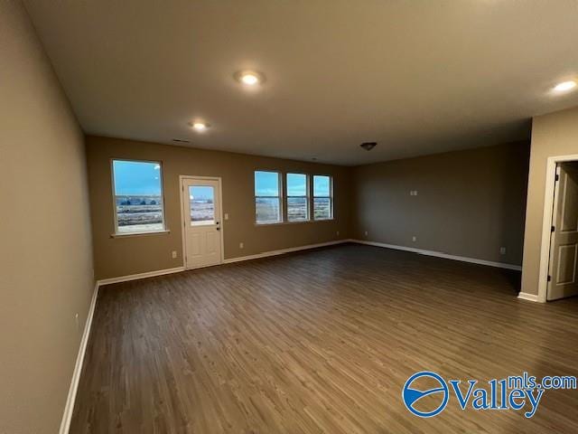 empty room featuring dark hardwood / wood-style flooring