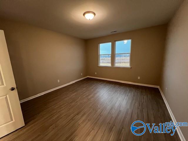 spare room with dark hardwood / wood-style floors