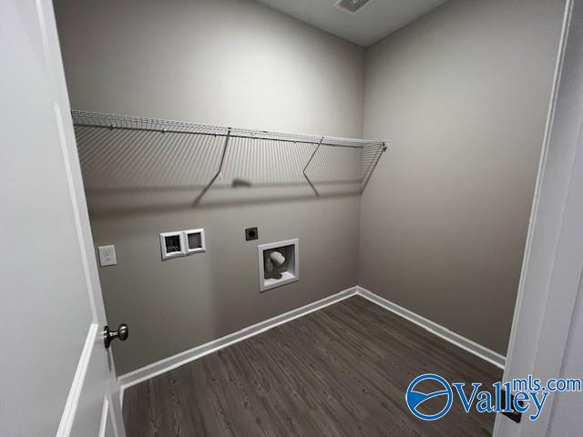 laundry area featuring electric dryer hookup, dark hardwood / wood-style flooring, and hookup for a washing machine