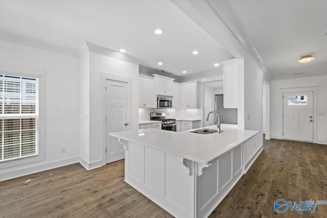 kitchen with white cabinets, appliances with stainless steel finishes, dark wood-type flooring, and sink