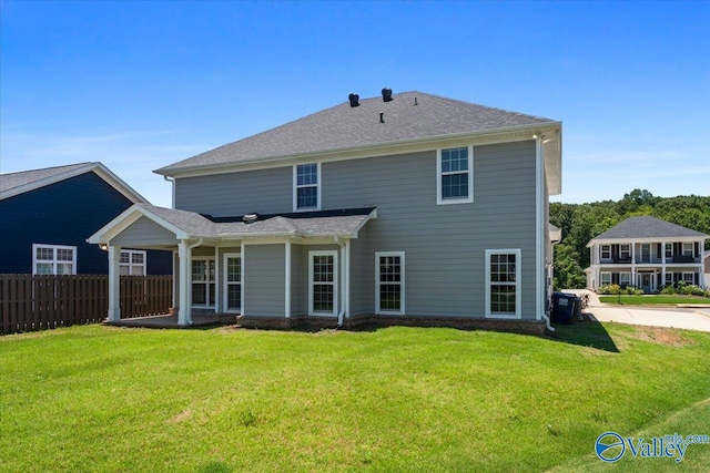 rear view of property featuring a yard