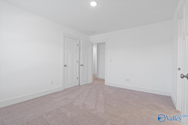 empty room featuring light colored carpet