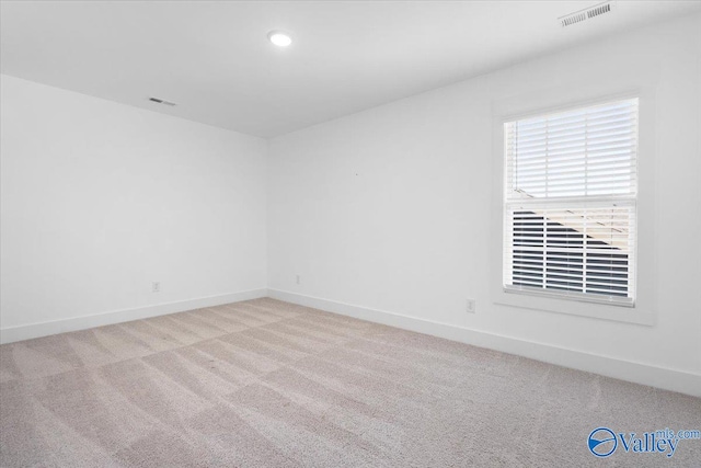 spare room featuring light colored carpet