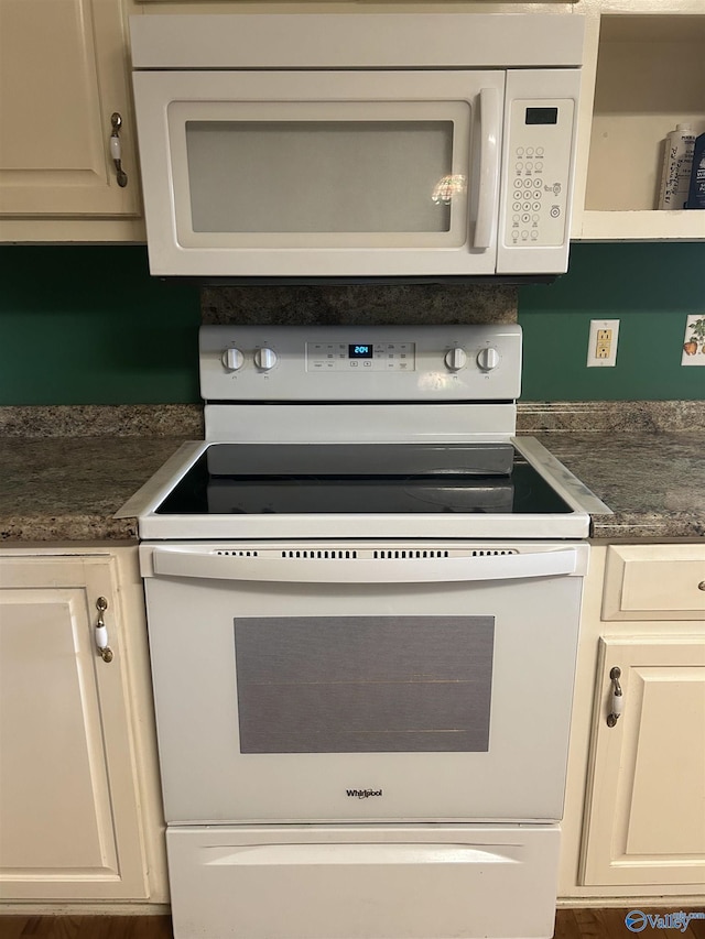 kitchen featuring white cabinetry and white appliances