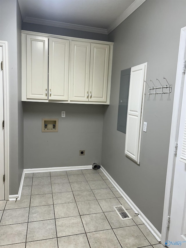 laundry room featuring cabinets, ornamental molding, washer hookup, light tile patterned floors, and electric dryer hookup