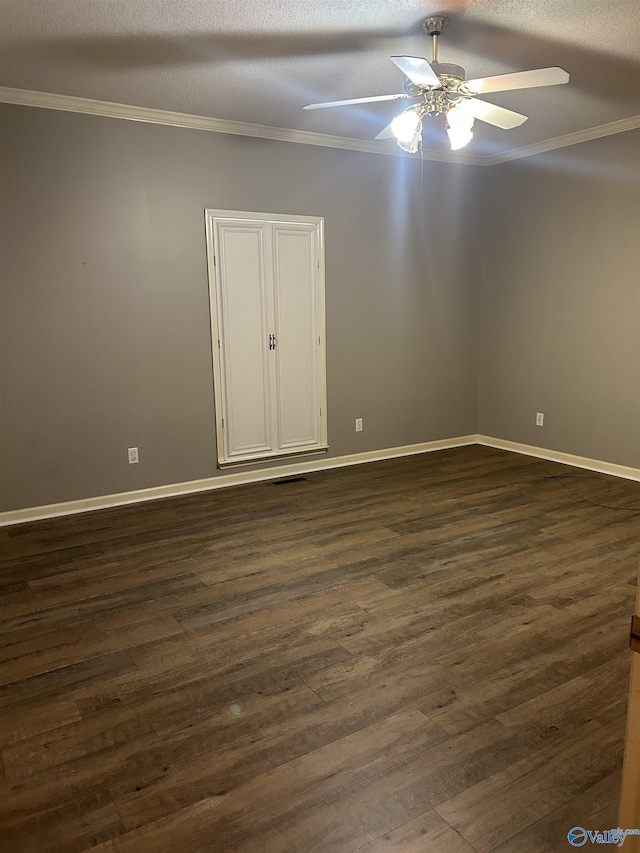 spare room with crown molding, dark wood-type flooring, and ceiling fan