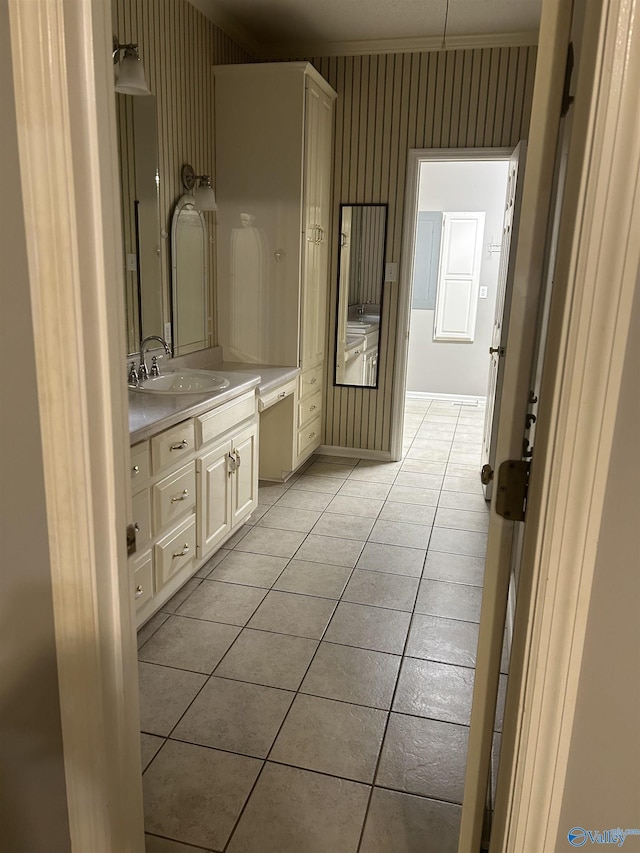 bathroom with vanity, ornamental molding, and tile patterned floors