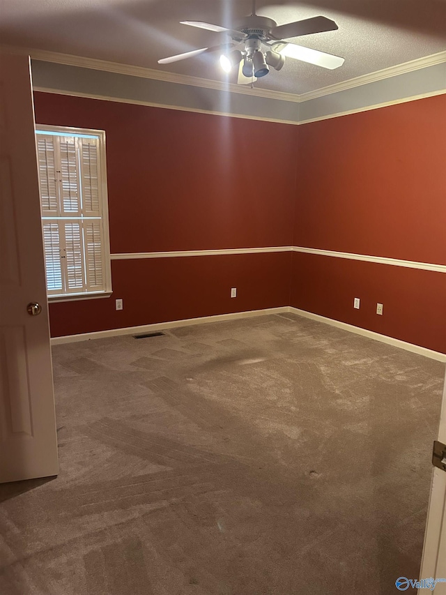 carpeted spare room featuring ornamental molding and ceiling fan