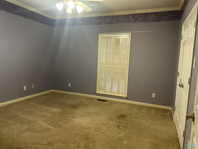 carpeted empty room with crown molding and ceiling fan