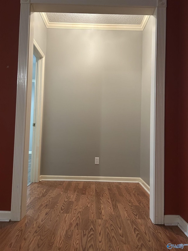 empty room featuring crown molding