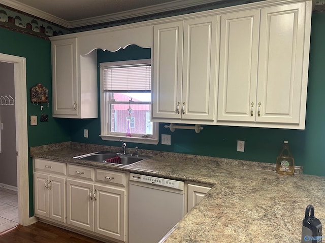 kitchen featuring white cabinetry, dishwasher, and sink