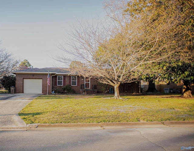 view of front facade with a front yard, brick siding, concrete driveway, and an attached garage