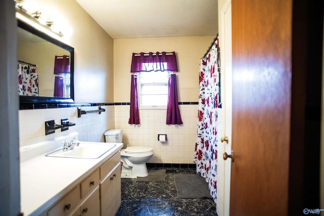 full bathroom with tile walls, wainscoting, toilet, and vanity