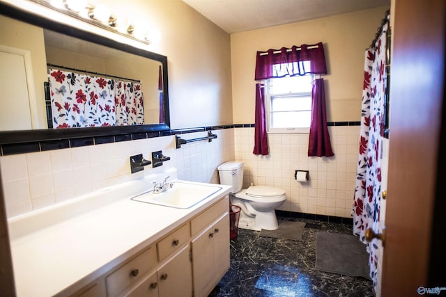 full bath featuring wainscoting, vanity, tile walls, and toilet