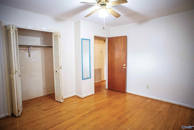 unfurnished bedroom featuring visible vents, a ceiling fan, wood finished floors, a closet, and baseboards