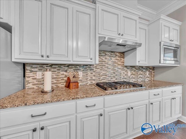 kitchen featuring stainless steel appliances, white cabinetry, and under cabinet range hood