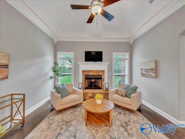 living room featuring baseboards, ceiling fan, and wood finished floors