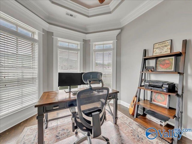 office featuring baseboards, ornamental molding, wood finished floors, and a wealth of natural light