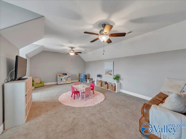rec room featuring visible vents, light carpet, baseboards, ceiling fan, and vaulted ceiling