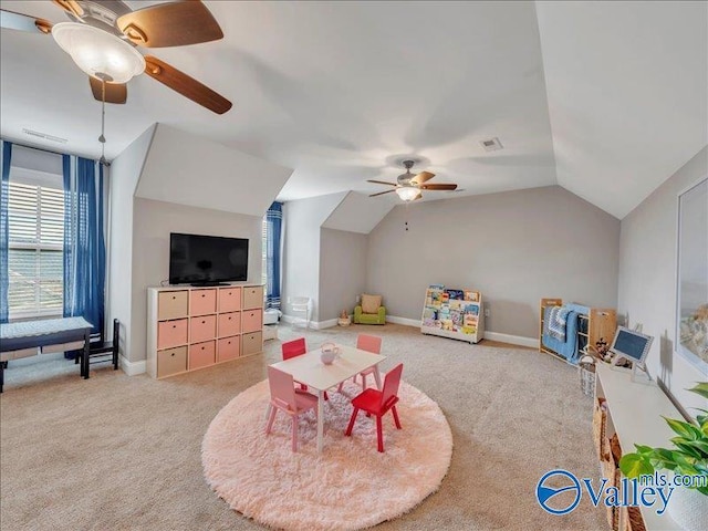 playroom with vaulted ceiling, visible vents, a ceiling fan, and light colored carpet