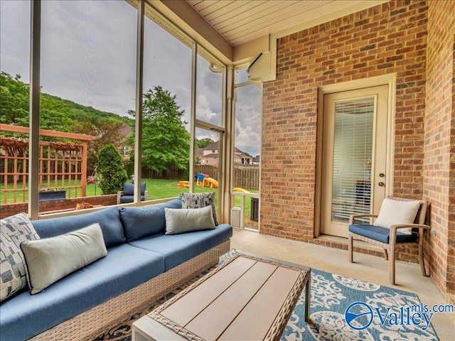 sunroom featuring an outdoor living space