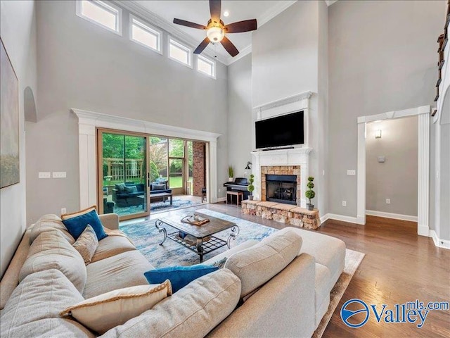 living area with plenty of natural light, a high ceiling, and a ceiling fan