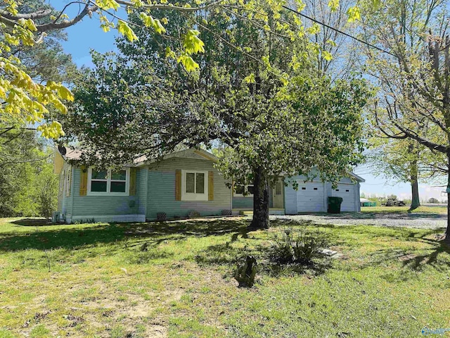 view of front of home with a front yard and an attached garage