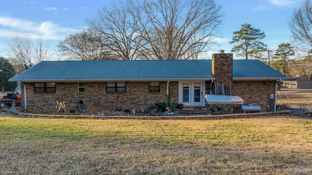 rear view of house with a lawn