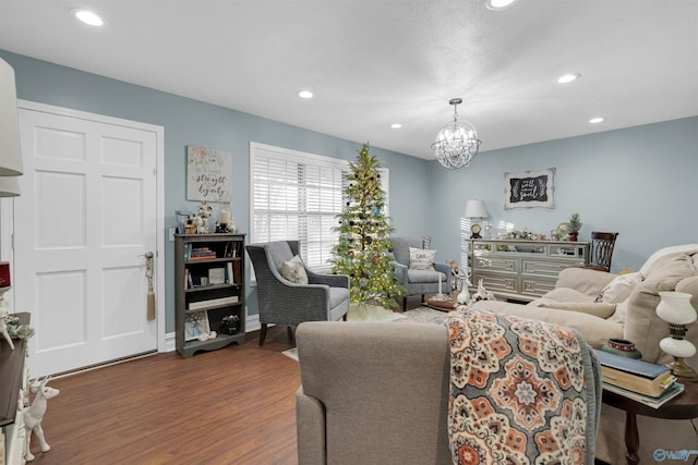 living room featuring dark wood-type flooring and an inviting chandelier