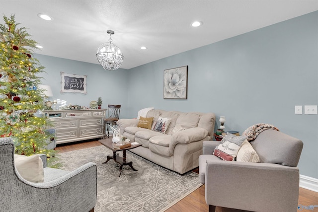 living room featuring an inviting chandelier and light hardwood / wood-style flooring