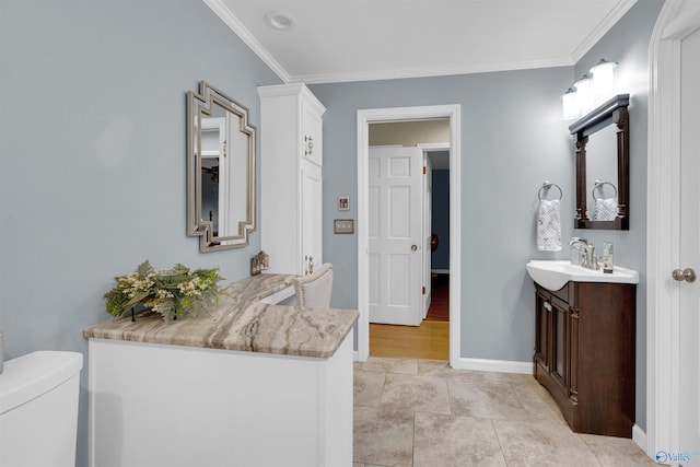 bathroom featuring toilet, vanity, ornamental molding, and tile patterned flooring