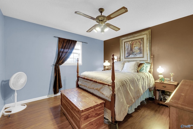 bedroom with ceiling fan and dark hardwood / wood-style flooring