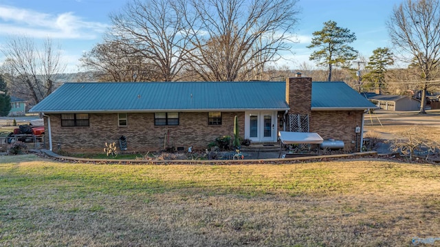 back of property featuring a yard