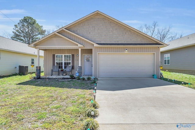 view of front of house featuring an attached garage, concrete driveway, board and batten siding, cooling unit, and a porch