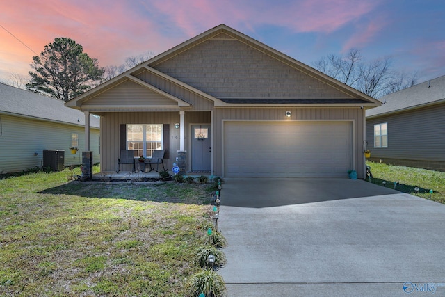 view of front of house featuring a garage, central AC unit, board and batten siding, and a porch