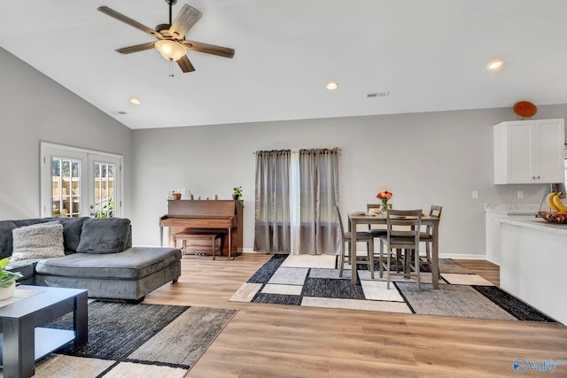 living room featuring visible vents, light wood finished floors, ceiling fan, recessed lighting, and lofted ceiling