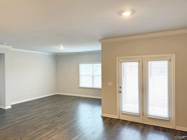 unfurnished room featuring dark wood-type flooring, crown molding, and baseboards