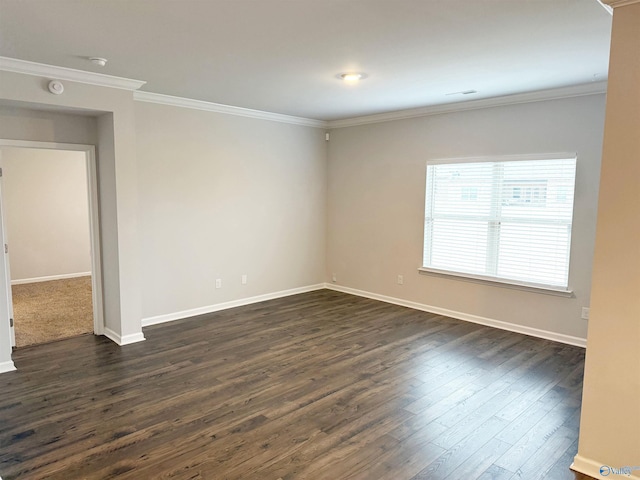 unfurnished room with visible vents, baseboards, dark wood finished floors, and crown molding