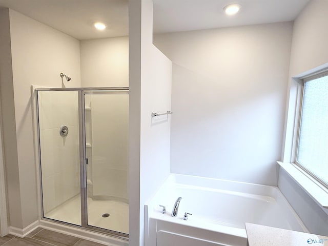 full bath with a shower stall, a bath, and recessed lighting