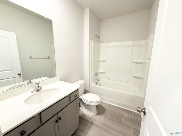 bathroom featuring vanity, shower / tub combination, and toilet