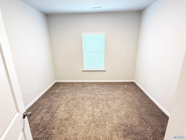 carpeted empty room featuring visible vents and baseboards