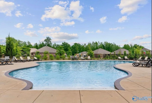 pool featuring a patio area and fence