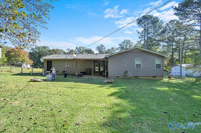 rear view of property featuring a yard